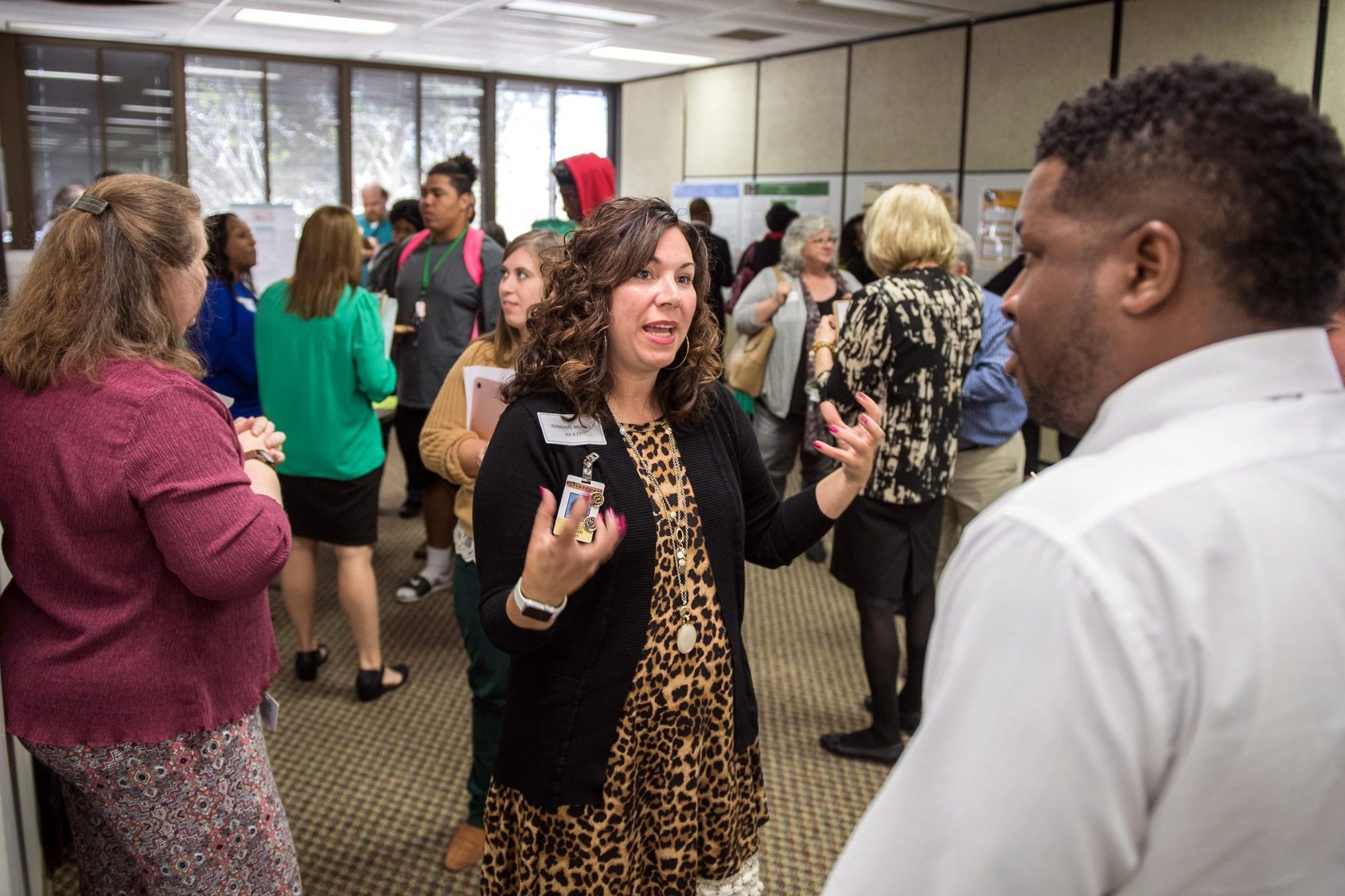 Graduate Student presenting research at research exposition.